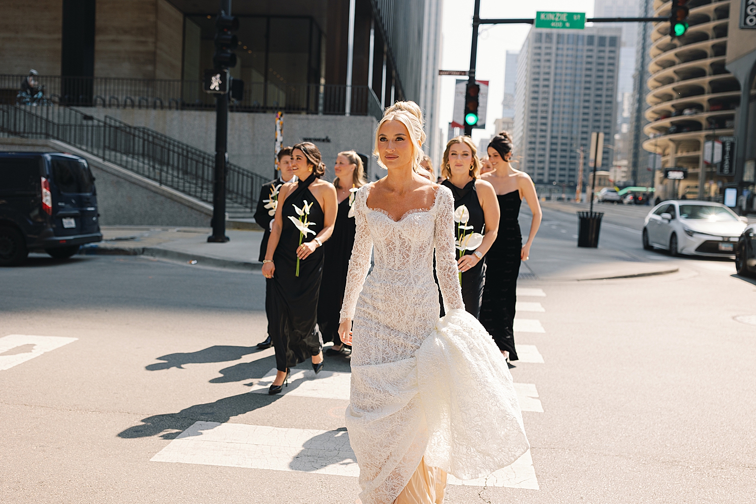 bride walks across the street with bridesmaids before day at RPM Events