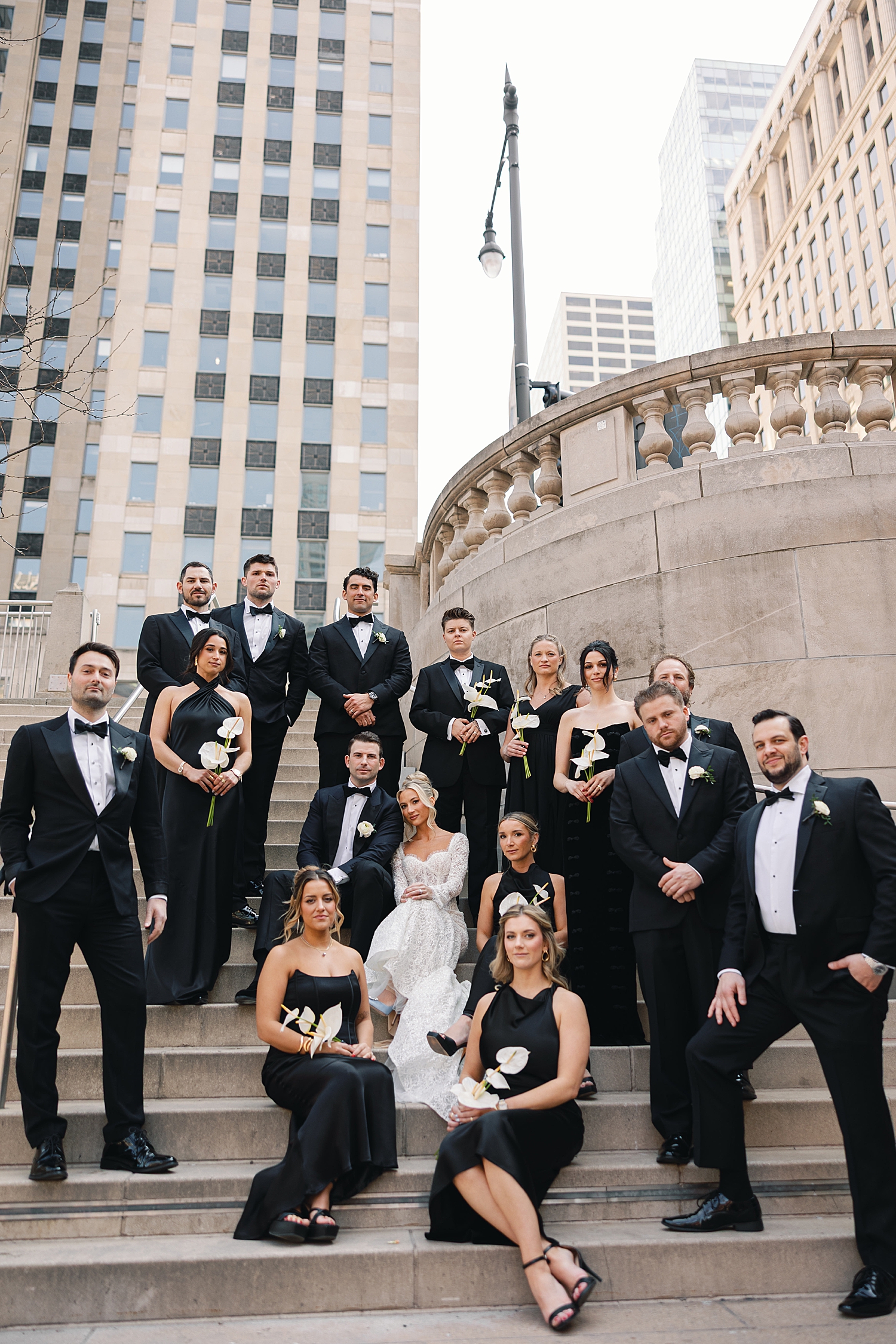 bridal party surrounds couple on outdoor steps before ceremony at RPM Events