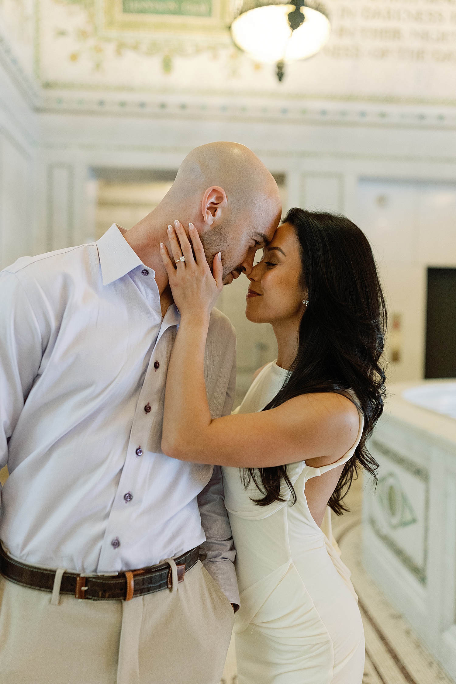 woman leans in to hold man's face by Rachel Andrade Photography