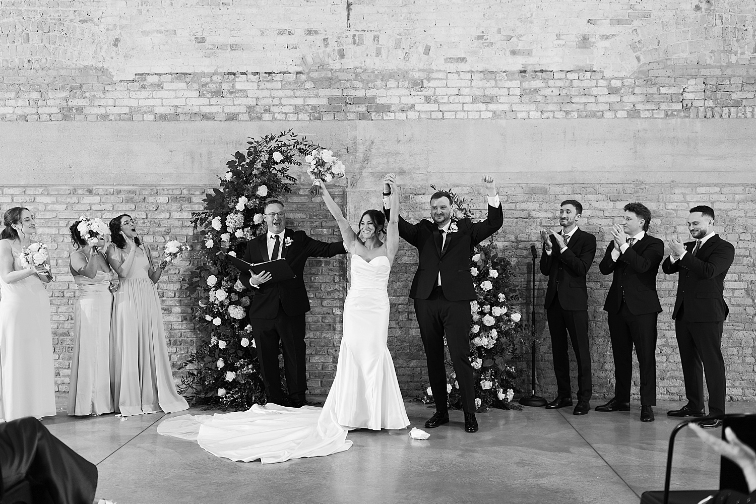 bride and groom share a cheer after saying I do by Chicago editorial photographer